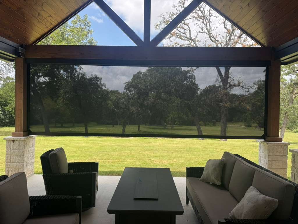 Large motorized exterior roller shade covering an outdoor living area